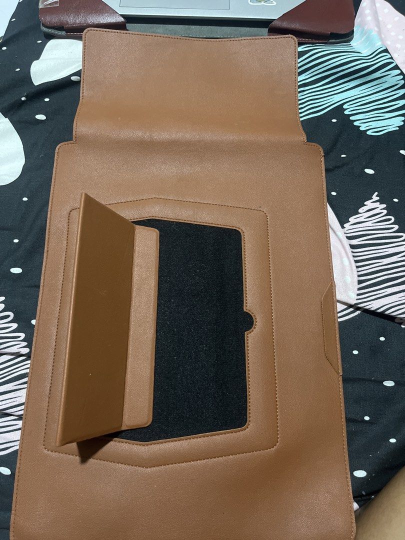 Brown Leather Laptop Sleeve with Stand (Category: Laptop Bags & Sleeves) located in Naga. Submitted by Carmel_C (Listing ID 1457662026, Image 3). Description: - Premium brown leather laptop sleeve - Integrated stand for hands-free viewing - Designed to fit most standard laptops - Convenient exterior pocket for accessories - Offers excellent protection for your device on the go - Sleek and minimalist design.