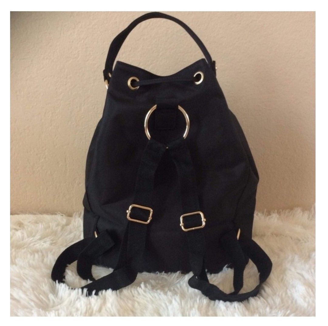 CC VIP Drawstring Bag (Category: Luxury Bags & Wallets) located in Makati City. Submitted by yerbua103 (Listing ID 1457684038, Image 2). Description: This is a black Chanel VIP drawstring bag/mini backpack featuring a prominent CC logo patch. It has a gold-tone hardware and a black nylon drawstring closure. First 2 pics are for reference only. Manage your expectations as you're buying a preloved/ukay bag. .