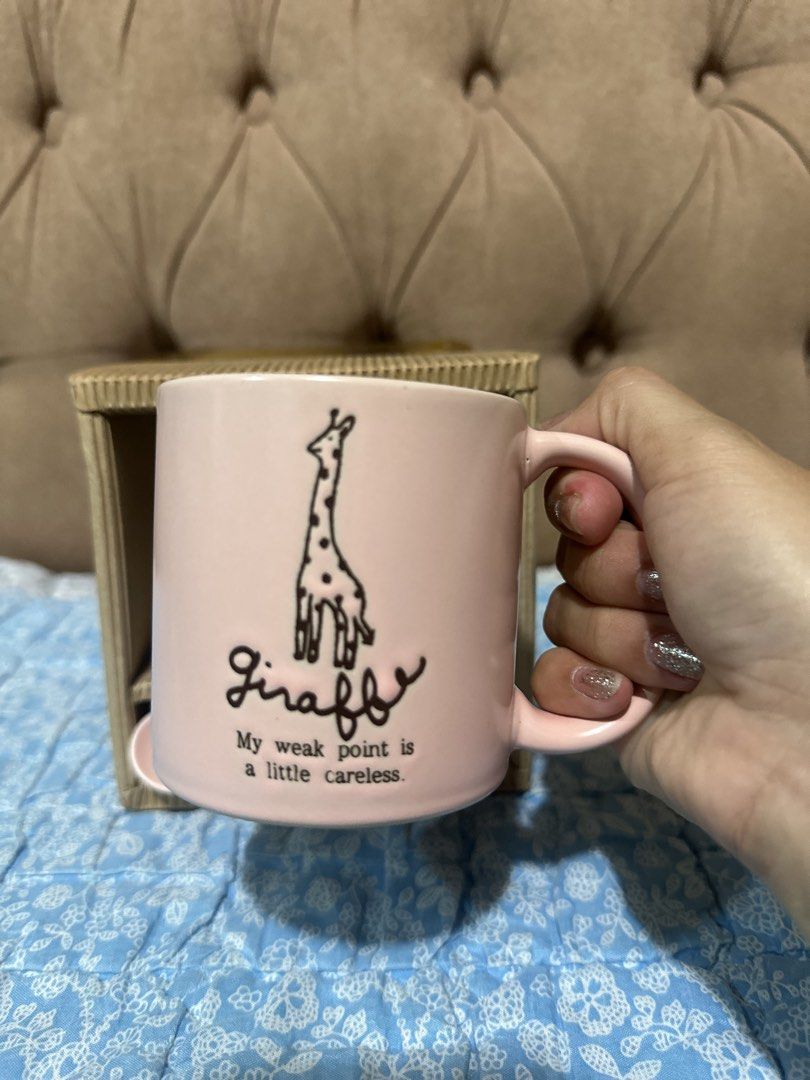 ceramic coffee mug set with spoon (Category: Coffee & Tea Tableware) located in Davao. Submitted by favoritepreloved (Listing ID 1457648965, Image 2). Description: 💜 features a cute giraffe illustration with the text "My weak point is a little careless" and includes a matching spoon in a presentation box..