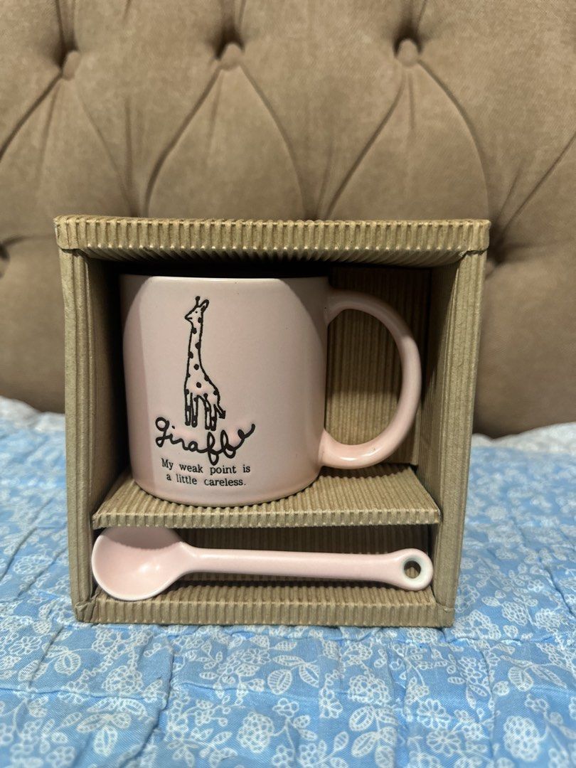 ceramic coffee mug set with spoon (Category: Coffee & Tea Tableware) located in Davao. Submitted by favoritepreloved (Listing ID 1457648965, Image 1). Description: 💜 features a cute giraffe illustration with the text "My weak point is a little careless" and includes a matching spoon in a presentation box..
