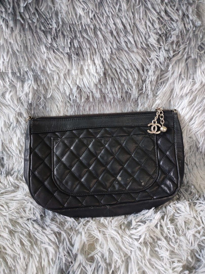 Chanel Black Quilted Leather Clutch Bag (Category: Luxury Bags & Wallets) located in Manila. Submitted by camellesal67218 (Listing ID 1457565416, Image 2). Description: - Classic Chanel clutch in black quilted leather - Iconic embossed CC logo on the front - Secure zipper closure - Perfect for evenings or everyday style - A timeless addition to any collection - Not guaranteed ISSUE: no sling.