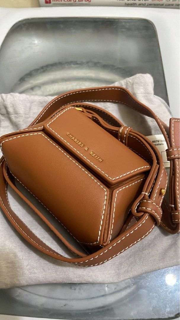 Charles & Keith Nasrin Geometric Mini Bag Chocolate XS (Category: Cross-body Bags) located in Santa Rosa. Submitted by nes_936 (Listing ID 1457698917, Image 2). Description: -Charles & Keith Nasrin Geometric Mini Bag - Color: Chocolate - Size: XS - Original Price: P2,999.00 - Includes: Dust bag and original tag - Condition: unused, brand new, with cardholder inside, Selling as is (please check photos for details).