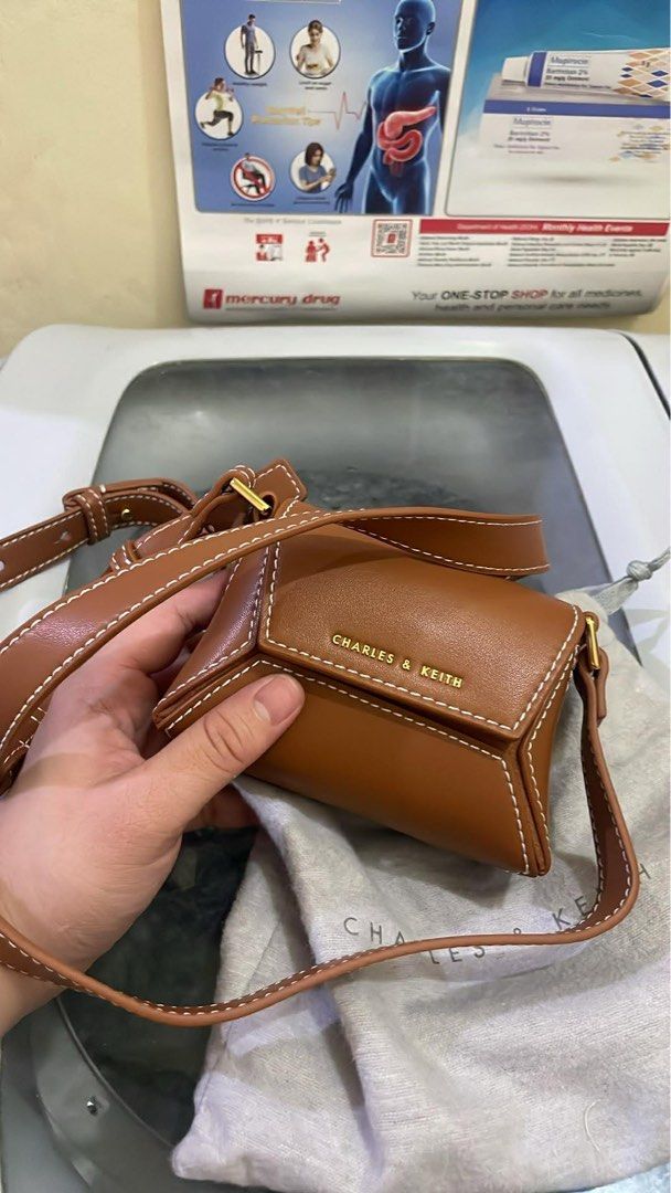 Charles & Keith Nasrin Geometric Mini Bag Chocolate XS (Category: Cross-body Bags) located in Santa Rosa. Submitted by nes_936 (Listing ID 1457698917, Image 1). Description: -Charles & Keith Nasrin Geometric Mini Bag - Color: Chocolate - Size: XS - Original Price: P2,999.00 - Includes: Dust bag and original tag - Condition: unused, brand new, with cardholder inside, Selling as is (please check photos for details).