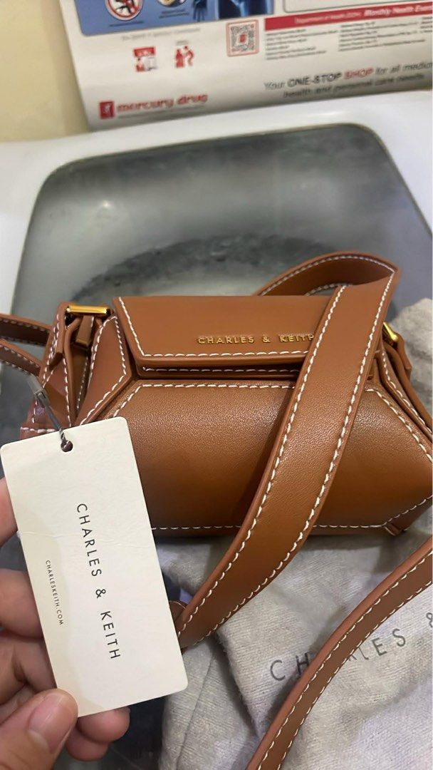 Charles & Keith Nasrin Geometric Mini Bag Chocolate XS (Category: Cross-body Bags) located in Santa Rosa. Submitted by nes_936 (Listing ID 1457698917, Image 3). Description: -Charles & Keith Nasrin Geometric Mini Bag - Color: Chocolate - Size: XS - Original Price: P2,999.00 - Includes: Dust bag and original tag - Condition: unused, brand new, with cardholder inside, Selling as is (please check photos for details).