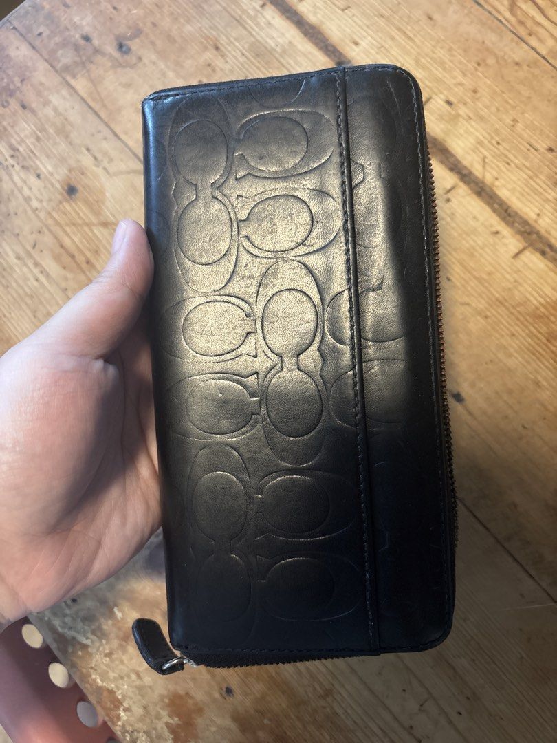 Coach Black Embossed Monogram Zip Around Wallet (Category: Luxury Bags & Wallets) located in Mabalacat. Submitted by maebirayd (Listing ID 1457544615, Image 2). Description: - Authentic Coach wallet - Signature monogram embossing - Zip-around closure - Multiple card slots and compartments - Central zippered coin pocket - Genuine leather material - Ideal for organizing essentials.