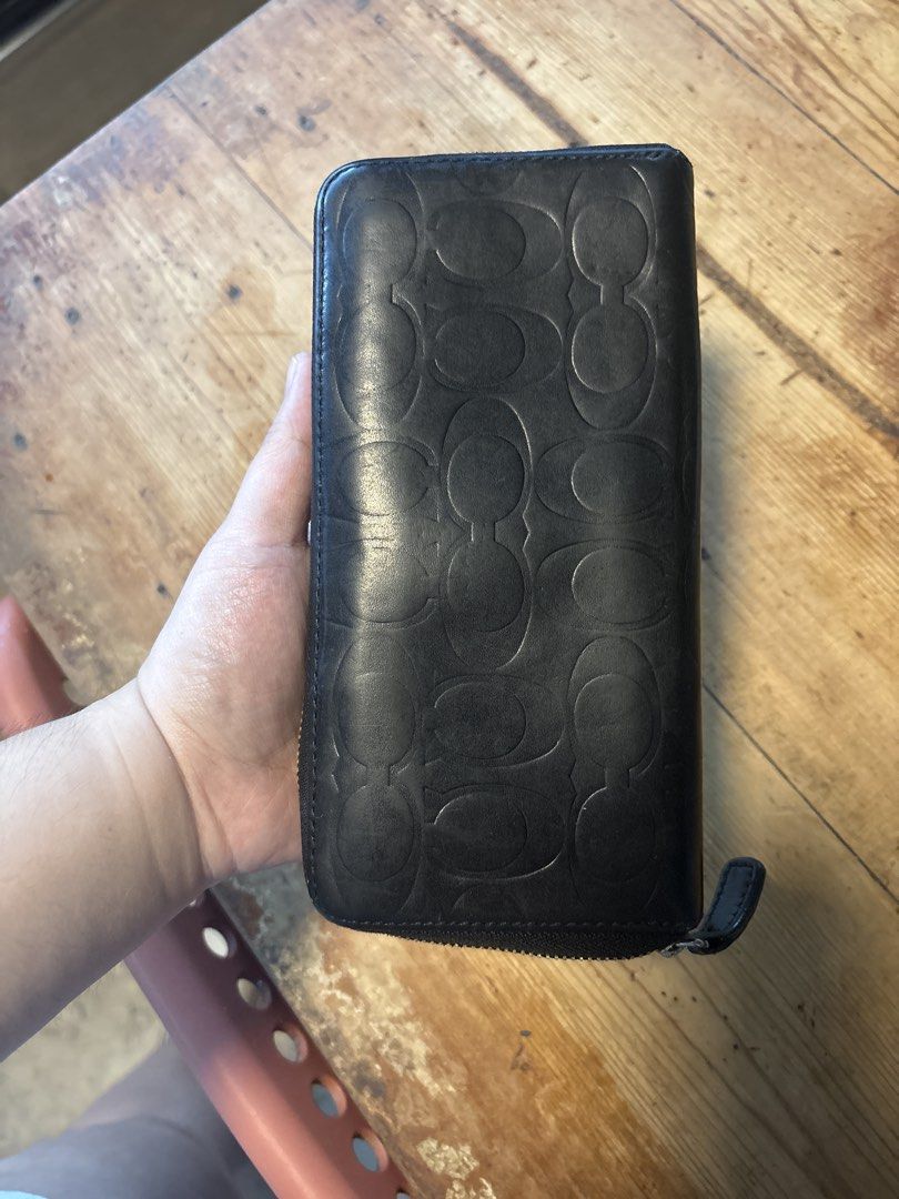 Coach Black Embossed Monogram Zip Around Wallet (Category: Luxury Bags & Wallets) located in Mabalacat. Submitted by maebirayd (Listing ID 1457544615, Image 1). Description: - Authentic Coach wallet - Signature monogram embossing - Zip-around closure - Multiple card slots and compartments - Central zippered coin pocket - Genuine leather material - Ideal for organizing essentials.