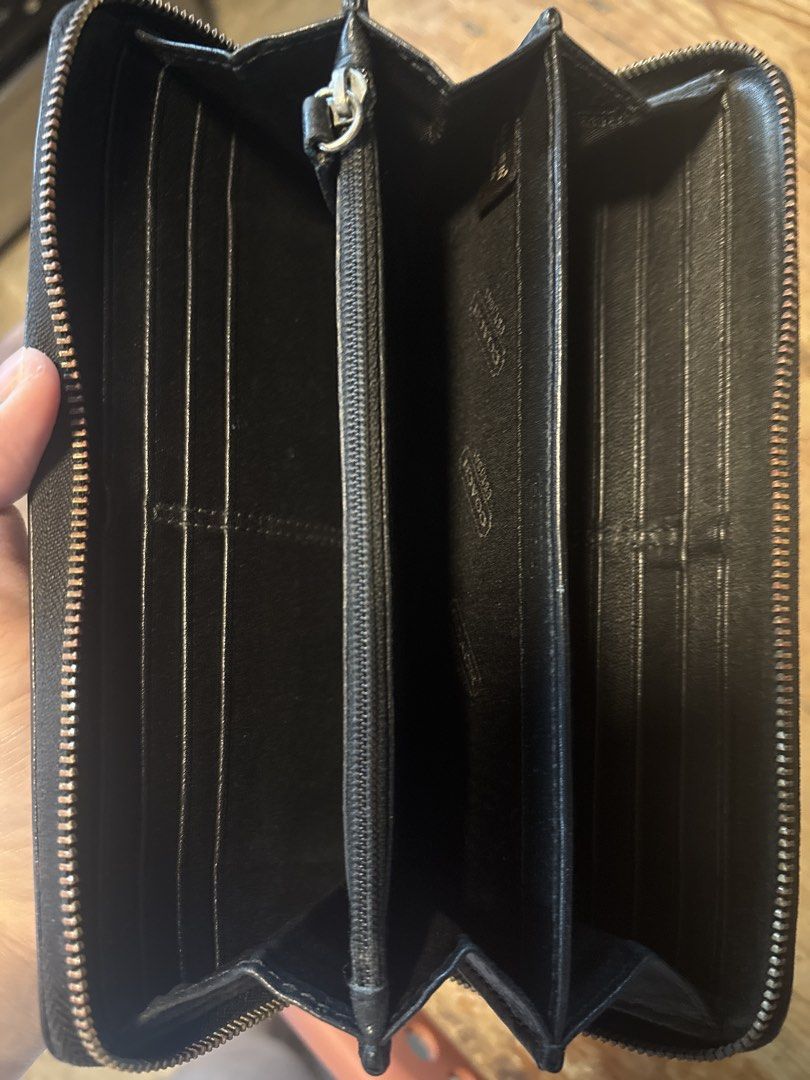 Coach Black Embossed Monogram Zip Around Wallet (Category: Luxury Bags & Wallets) located in Mabalacat. Submitted by maebirayd (Listing ID 1457544615, Image 3). Description: - Authentic Coach wallet - Signature monogram embossing - Zip-around closure - Multiple card slots and compartments - Central zippered coin pocket - Genuine leather material - Ideal for organizing essentials.