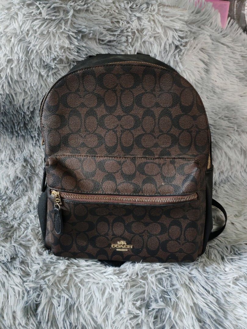 Coach Signature Monogram Backpack Brown Black (Category: Backpacks) located in Manila. Submitted by camellesal67218 (Listing ID 1457574448, Image 1). Description: - Coach backpack in signature brown and black monogram - Features stylish gold hardware zippers. - Interior includes a classic Coach New York leather patch. - Ample space for all your essentials. - Ideal for everyday use or travel adventures..