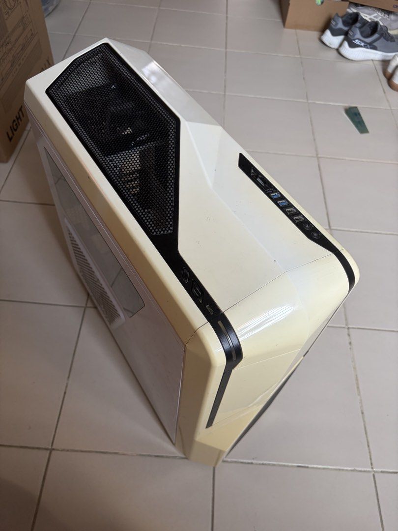 Computer case (Category: Computer Parts) located in Singapore. Submitted by heymarco26 (Listing ID 1457671996, Image 2). Description: Selling well used computer casing. Model is NZXT Phantom 410. Have cleaned out the interior and exterior. Slight yellowish discoloration of the plastic but other wise still usable. Suitable for ATX mother board and have all the compartments needed. - White/Cream ATX Mid-Tower PC Case - Features a side window for co