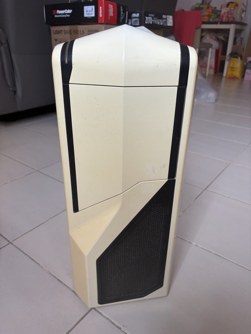 Computer case (Category: Computer Parts) located in Singapore. Submitted by heymarco26 (Listing ID 1457671996, Image 1). Description: Selling well used computer casing. Model is NZXT Phantom 410. Have cleaned out the interior and exterior. Slight yellowish discoloration of the plastic but other wise still usable. Suitable for ATX mother board and have all the compartments needed. - White/Cream ATX Mid-Tower PC Case - Features a side window for co