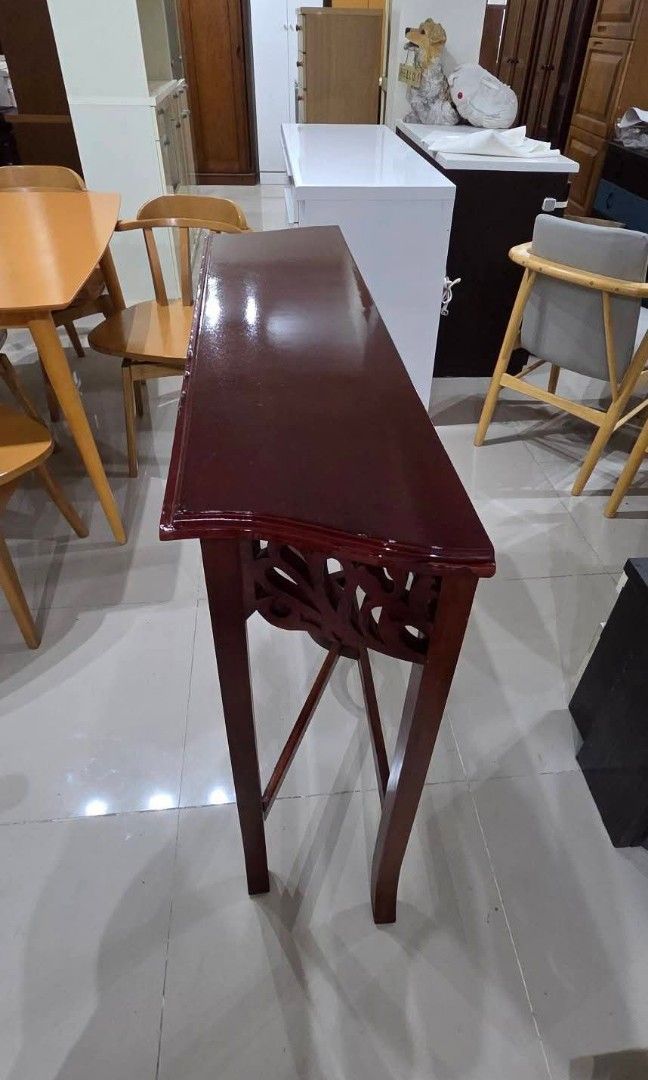 Console table (Category: TV Consoles) located in Quezon City. Submitted by jmandchad143 (Listing ID 1457517857, Image 3). Description: For sale! Console wood table OR Hallway table featuring an ornate, open-carved apron and a crossed stretcher base. Solid wood Malinis Quality japan surplus Guaranteed item is in good condition and clean.