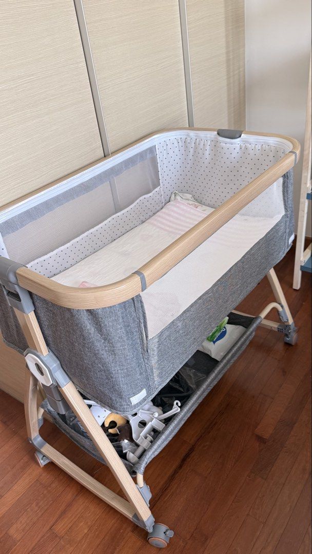 Cot (Category: Cots & Cribs) located in Singapore. Submitted by monica5656 (Listing ID 1457591189, Image 4). Description: - Stylish cot with grey fabric and natural wood trim - Mesh sides for optimal airflow - Equipped with wheels for easy maneuverability.