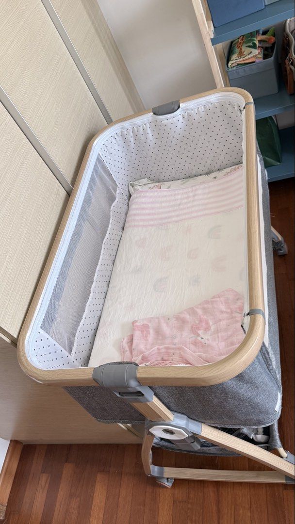 Cot (Category: Cots & Cribs) located in Singapore. Submitted by monica5656 (Listing ID 1457591189, Image 3). Description: - Stylish cot with grey fabric and natural wood trim - Mesh sides for optimal airflow - Equipped with wheels for easy maneuverability.
