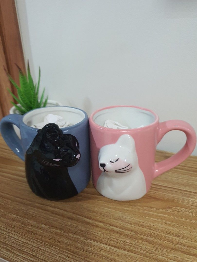 Cute Cat/Bear Ceramic Mugs - Pink and Blue (Category: Coffee & Tea Tableware) located in Quezon City. Submitted by cheche14 (Listing ID 1457603114, Image 1). Description: - Set of 2 adorable ceramic mugs - Pink mug features a cute white sleeping bear design - Blue mug features a cute black sleeping cat design - Both mugs have comfortable handles - Ideal for your morning coffee or tea - Makes a perfect gift for animal lovers - Doubles as charming 