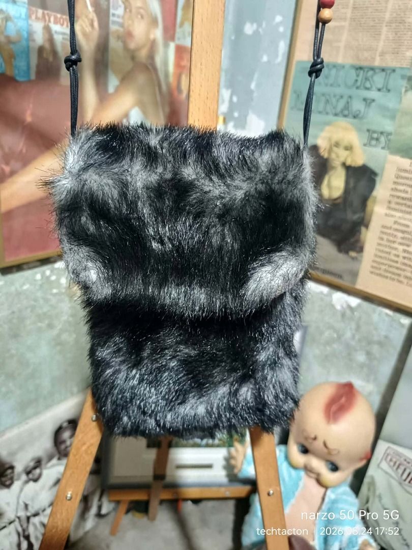 Cute Faux Fur Sling Mini Bag (Category: Shoulder Bags) located in Santo Tomas. Submitted by pickers_corner (Listing ID 1457519167, Image 2). Description: FUR Sling bag no brand dime 8x6x2in - Small fuzzy bag in black and grey faux fur. - Secure magnetic snap closure. - Lined interior with black fabric. - Ideal for carrying essentials (keys, cards, lipstick). - A fun accessory for nights out or adding flair to any outfit..