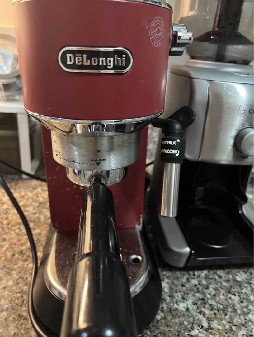 DeLonghi Red Espresso Machine & Cuppa Coffee Grinder (Category: Coffee Machines & Makers) located in Makati City. Submitted by EJDbad (Listing ID 1457539104, Image 1). Description: - DeLonghi red espresso machine - Built-in steam wand for perfect milk frothing - Includes Cuppa coffee grinder with timer settings - Both items are in good working condition - Ideal for creating your favorite coffee drinks at home.