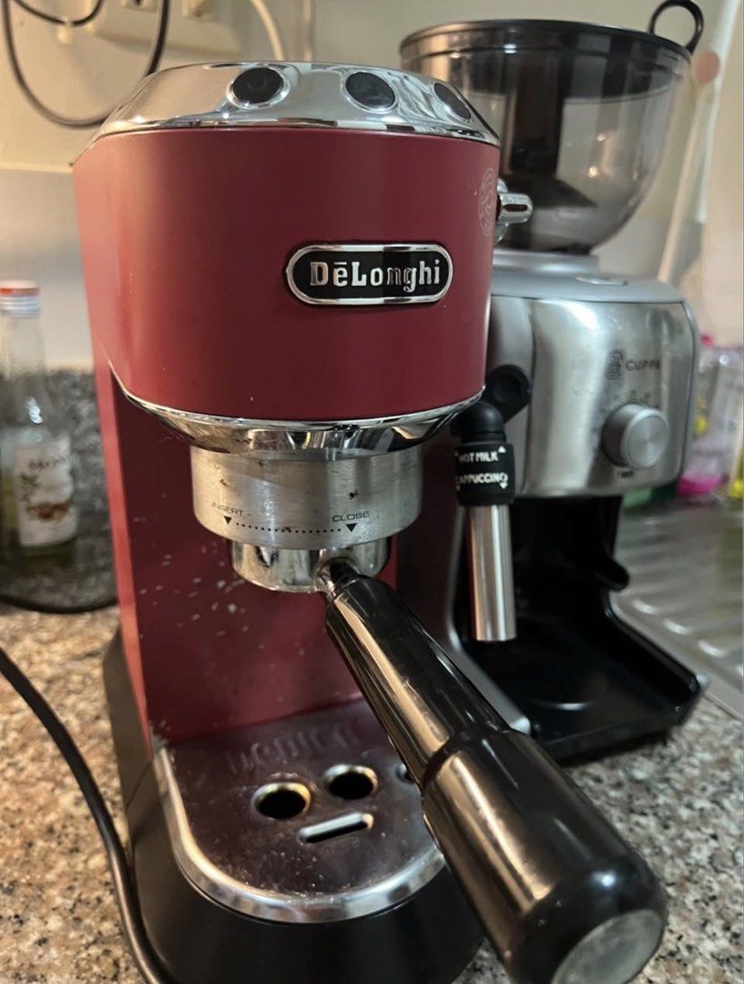 DeLonghi Red Espresso Machine & Cuppa Coffee Grinder (Category: Coffee Machines & Makers) located in Makati City. Submitted by EJDbad (Listing ID 1457539104, Image 2). Description: - DeLonghi red espresso machine - Built-in steam wand for perfect milk frothing - Includes Cuppa coffee grinder with timer settings - Both items are in good working condition - Ideal for creating your favorite coffee drinks at home.