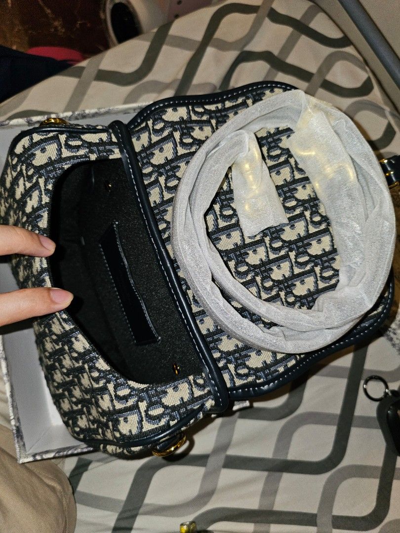 Dior Oblique Saddle Bag (Category: Luxury Bags & Wallets) located in Caloocan City. Submitted by kingarthur1306 (Listing ID 1457702450, Image 3). Description: - High Tier - Classic Dior Oblique canvas - Gold hardware details - Comes with dust bag and box - Ideal for everyday or special occasions - A timeless Dior piece.
