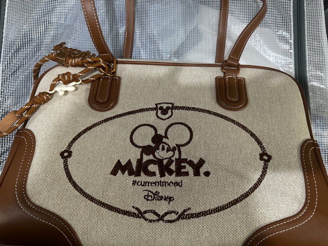 Disney Mickey Mouse Top-Handle Bag with Keychain Pendant (Category: Shoulder Bags) located in Manila. Submitted by shysilver (Listing ID 1457616905, Image 1). Description: - Adorable Disney top-handle bag - Features a cute Mickey Mouse graphic - "#currentmood" text detail - Comes with a stylish braided keychain pendant - Chic brown trim and handles - Ideal for everyday use or as a fun fashion accessory Other details: Only used twice No box includ