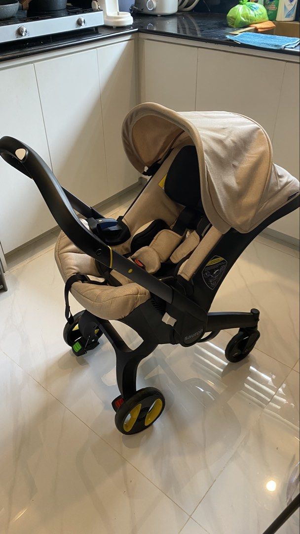 Doona inspired Infant Car Seat & Stroller - Beige (Category: Strollers) located in Santa Barbara. Submitted by msdo.11 (Listing ID 1457666868, Image 1). Description: - Converts from infant car seat to stroller - Ideal for travel and quick errands - Built-in canopy for sun protection - Secure safety harness for baby - Durable and sturdy wheels - Compact design for easy storage - Neutral and stylish beige color.