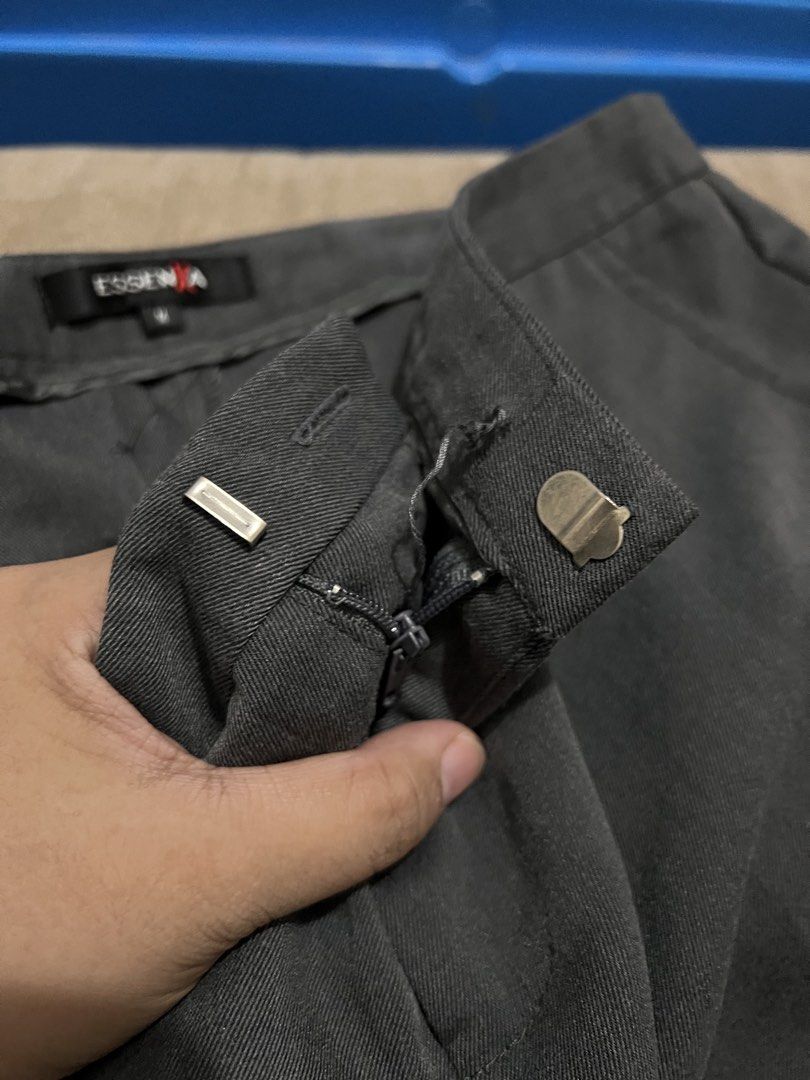 EssenXa Dark Gray Polyester Pants (Category: Other Bottoms) located in Manila. Submitted by jovalbarez (Listing ID 1457671643, Image 3). Description: Needs button repair and no back pockets. But pants is well-kept. RFS: Saglit lang ginamit bago kami nagka-uniform sa work. Di na din kasya. Brand: EssenXa Size: M Waist: 31 inch Length: 33 inch.