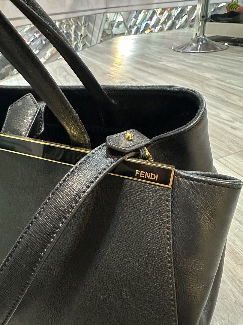 Fendi Black Leather Tote Bag (Category: Luxury Bags & Wallets) located in Baguio. Submitted by thirdy12493 (Listing ID 1457612691, Image 2). Description: - Classic black Fendi tote bag - Made from textured leather - Features top handles and a detachable shoulder strap - Elegant gold hardware details, including Fendi logo - Spacious interior for essentials - Ideal for daily use or travel.