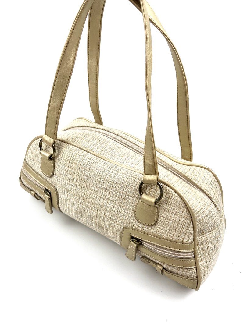 Glam Metallic Trim Bowler Bag (Category: Shoulder Bags) located in Angeles City. Submitted by fruits.ph (Listing ID 1457536544, Image 3). Description: Measurements: W: 13” H: 5.5” D: 4.5” Handle Drop: 9” *Flat lay measurements* Brand: N/A Type: Shoulder Bag Material: Canvas Color: Cream/Metallic Gold Capacity: Fits phone, wallet, sunglasses, small pouch & keys. Condition: 9/10 Flaws: Minor Exterior Stain(Back Part) and Interior Lining Yellow Stai