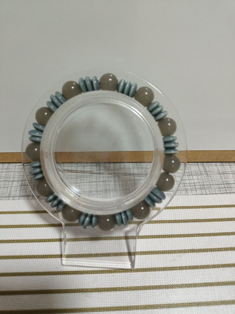 Grey agate and cat's eye beaded stretch bracelet (Category: Bracelets) located in Iloilo. Submitted by trinketsandtreasures.ph (Listing ID 1457522596, Image 1). Description: - Stretch bracelet for easy on-and-off wear. - Features grey agate beads with striking blue cat's accent beads. - Simple, versatile design suitable for daily use. - Adds a subtle pop of color to any outfit. .