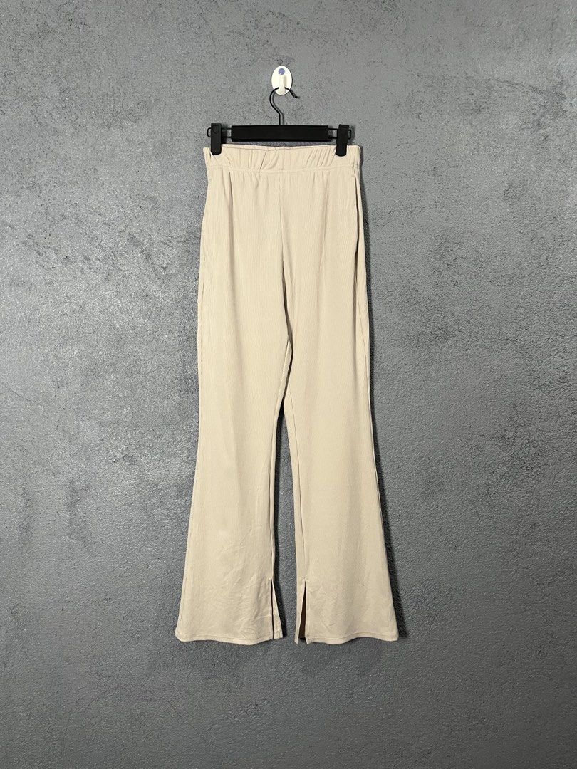 GU Ribbed Flare Pants Beige Size S (Category: Other Bottoms) located in Famy. Submitted by basicthrifted (Listing ID 1457568018, Image 1). Description: - Beige ribbed flare pants from GU - Comfortable elastic waistband - Stylish split hem detail - Super comfy and versatile for casual or dressed-up looks - Size S.