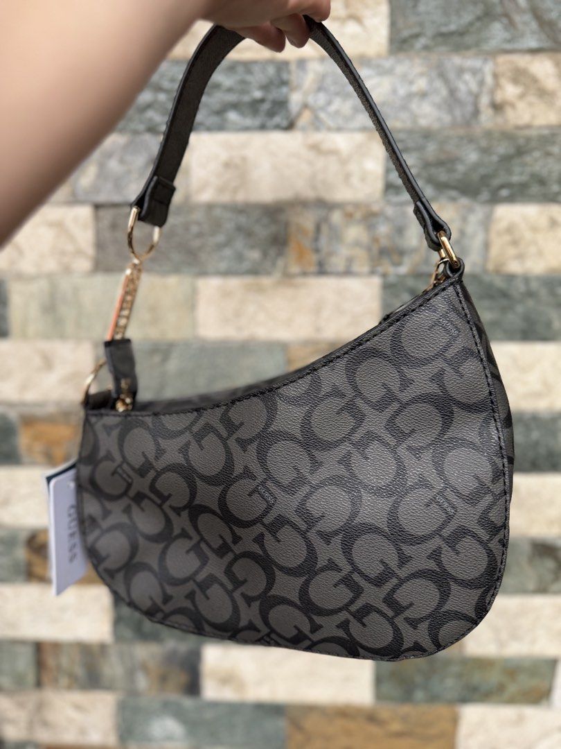 Guess Monogram Hobo Bag (Category: Luxury Bags & Wallets) located in Rizal. Submitted by bingbong21 (Listing ID 1457565825, Image 2). Description: - Authentic Grey Guess Hobo Bag - All-over monogram pattern for a stylish look - Elegant gold chain detail across the front - Adjustable strap for comfortable wear - Comes with original tag, brand new - Ideal for everyday use and adding flair to your outfits.