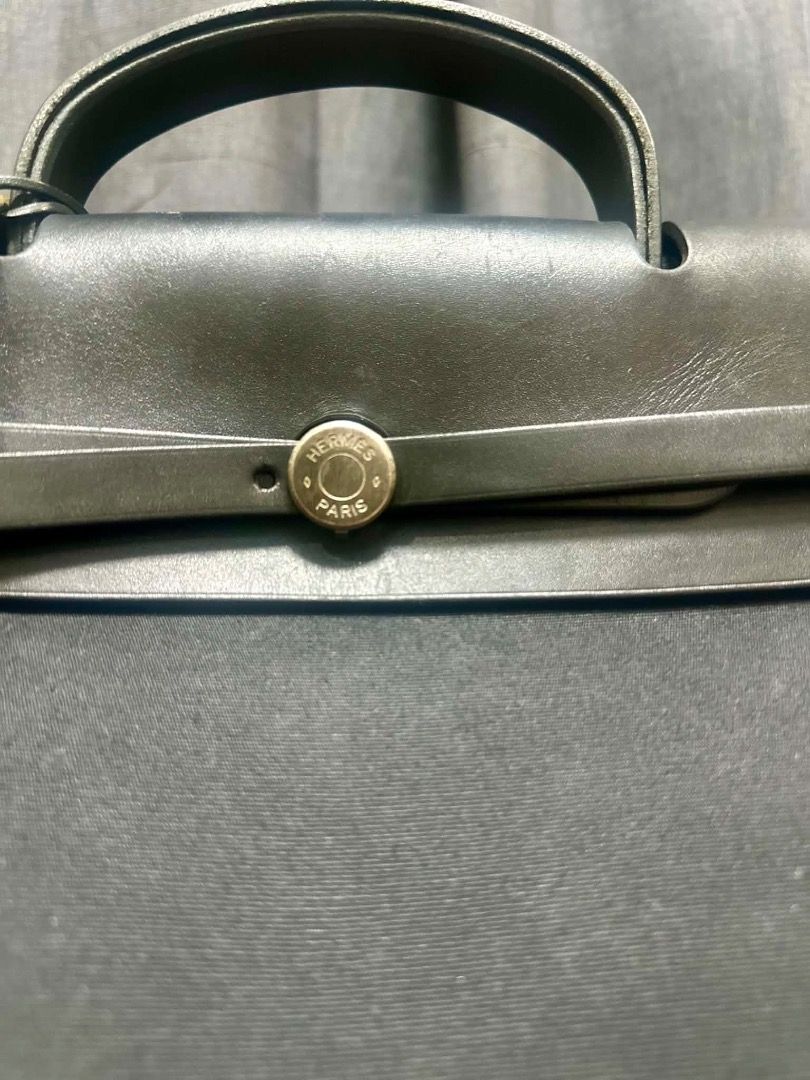 Hermes 35cm Herbag (Category: Luxury Bags & Wallets) located in Albuera. Submitted by zaraofdammam09 (Listing ID 1457518508, Image 3). Description: Herbag by Hermès in black canvas and black leather, with palladium hardware, a leather top handle, and a shoulder strap for hand, shoulder, or cross-body wear. Details: Flap with link fastener Black canvas lining Includes keys, padlock and clochette Stamped Condition: Very good.