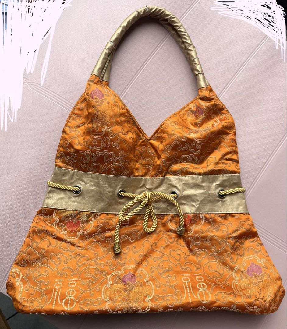 Hobo bag (Category: Shoulder Bags) located in Cainta. Submitted by klejre (Listing ID 1457611089, Image 1). Description: This is an orange and gold silk brocade hobo shoulder bag with a metallic gold band and drawstring detail..
