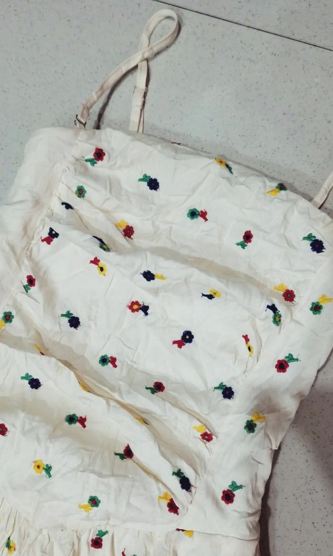 Ivory white with multicolored embroidered print maxi dress (Category: Dresses) located in Batangas. Submitted by micaelaul (Listing ID 1457608621, Image 2). Description: 32-34 bust 25-30 waist smock likod. Can be worn as tube or strappy, removable ang straps. May same design sa luxury brand. Keri Small-semi large.