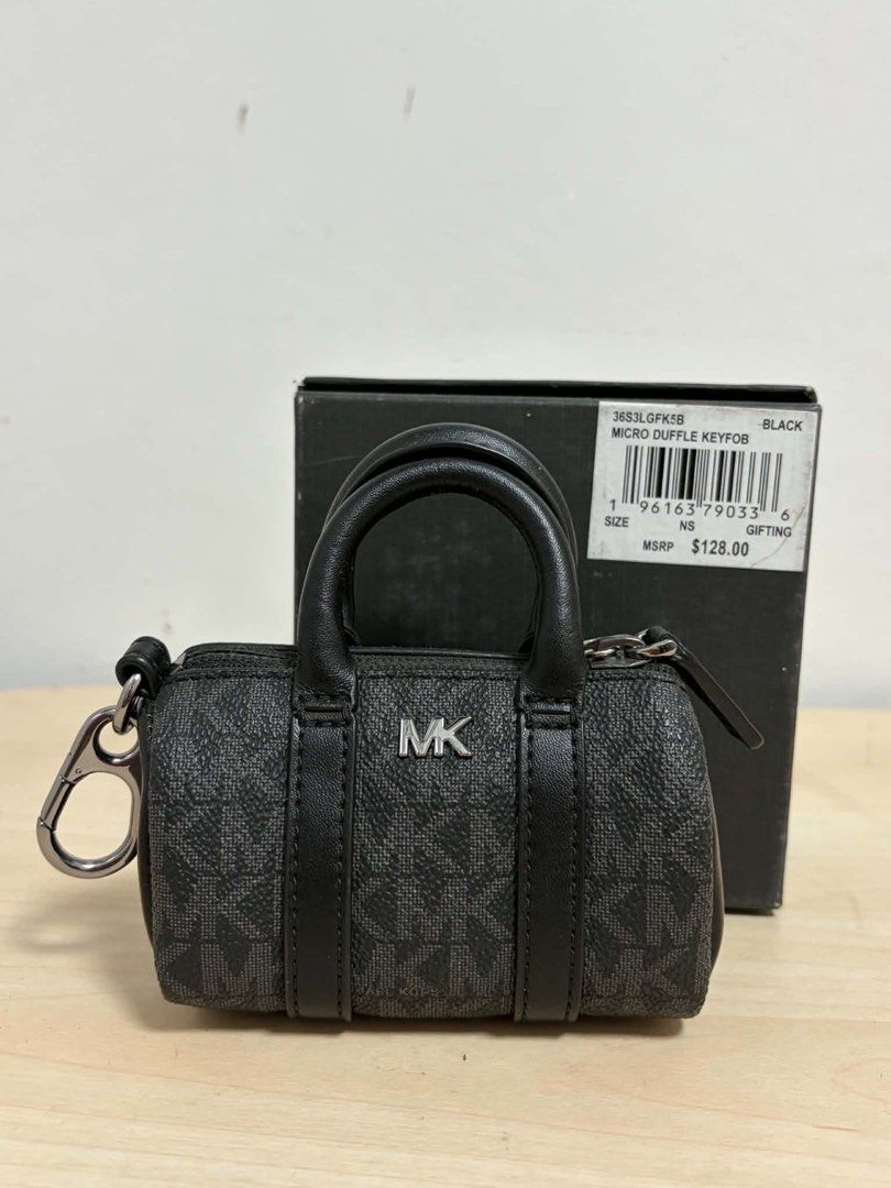 Michael Kors MK Micro Duffle Key Fob Black (Category: Luxury Bags & Wallets) located in Cavite. Submitted by genshop2019 (Listing ID 1457687241, Image 1). Description: - Authentic Michael Kors micro duffle key fob - Includes a keychain clip for easy attachment - Comes with its original box - Ideal for personalizing your bag or keys.