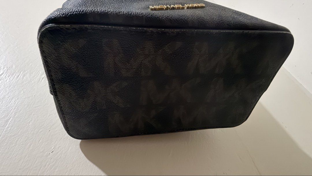 Michael Kors Suri Monogram Bucket Bag (Category: Luxury Bags & Wallets) located in Rizal. Submitted by lovegclothingph (Listing ID 1457645905, Image 2). Description: - Authentic Michael Kors bucket bag - Signature monogram print in dark brown and black - Secure drawstring closure - Elegant gold hardware - Interior zip and slip pockets - Made in Indonesia - With flaws inside and signs of usage (See photos for details) - No sling included - RFS: De