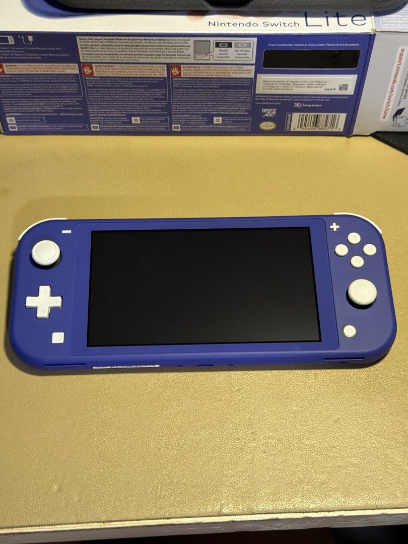 Nintendo Switch Lite - Blue (Category: Nintendo) located in Mandaluyong City. Submitted by msmika (Listing ID 1457573467, Image 2). Description: - Blue Nintendo Switch Lite - 32GB - Includes original box and charger - Comes with a protective case and installed screen protector worth 2.5k - All buttons and controls are in good working - bought in the US RFS: need extra funds.