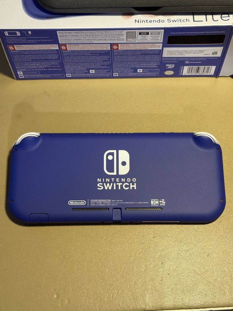 Nintendo Switch Lite - Blue (Category: Nintendo) located in Mandaluyong City. Submitted by msmika (Listing ID 1457573467, Image 3). Description: - Blue Nintendo Switch Lite - 32GB - Includes original box and charger - Comes with a protective case and installed screen protector worth 2.5k - All buttons and controls are in good working - bought in the US RFS: need extra funds.