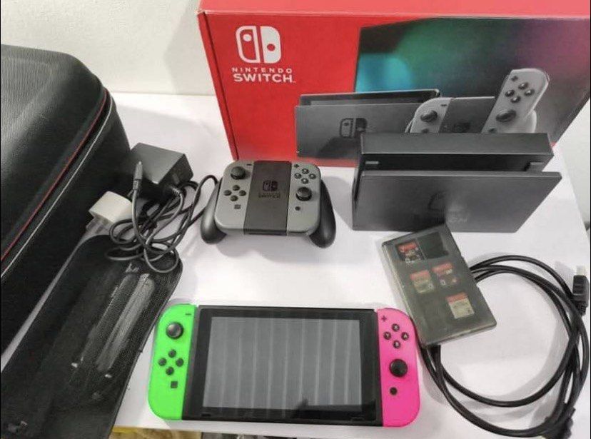 Nintendo Switch V2 Console with Games and Accessories (Category: Nintendo) located in Caloocan City. Submitted by zeonical2131 (Listing ID 1457697704, Image 1). Description: - Nintendo Switch Console - Includes Dock, Joy-Cons, and Charger - Comes with a Carrying Case - Games Included: Zelda, Mario Party, Super Smash Bros., NBA 2K20 - Ready for new adventures!.