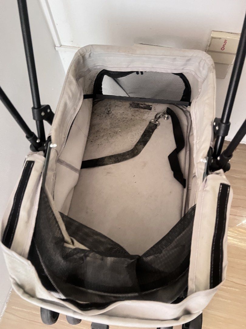 Pet Stroller for Dogs and Cats (Category: Homes & Other Pet Accessories) located in Malolos. Submitted by urgoodsfrommls (Listing ID 1457591138, Image 2). Description: - Used pet stroller, perfect for small to medium-sized pets. - Features a convenient folding mechanism for easy storage. - Includes a spacious storage basket at the bottom for your essentials. - All wheels are in good working condition. - Despite minor cosmetic wear, the stroller r