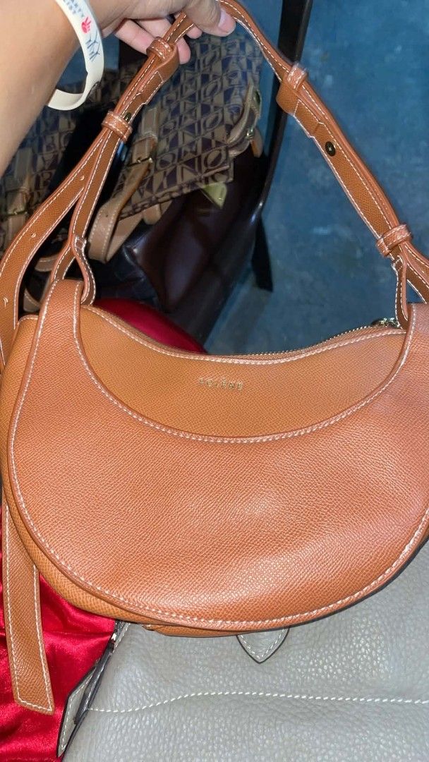 Polene Bag - Brown Crescent Shoulder Bag (Category: Luxury Bags & Wallets) located in Manila. Submitted by kylegaylic83622 (Listing ID 1457643176, Image 3). Description: - Brand: Polene - Style: Crescent shoulder bag - Color: Brown - Material: Leather - Details: White stitching, zipper closure, interior pocket, adjustable strap - Ideal for: Everyday use.