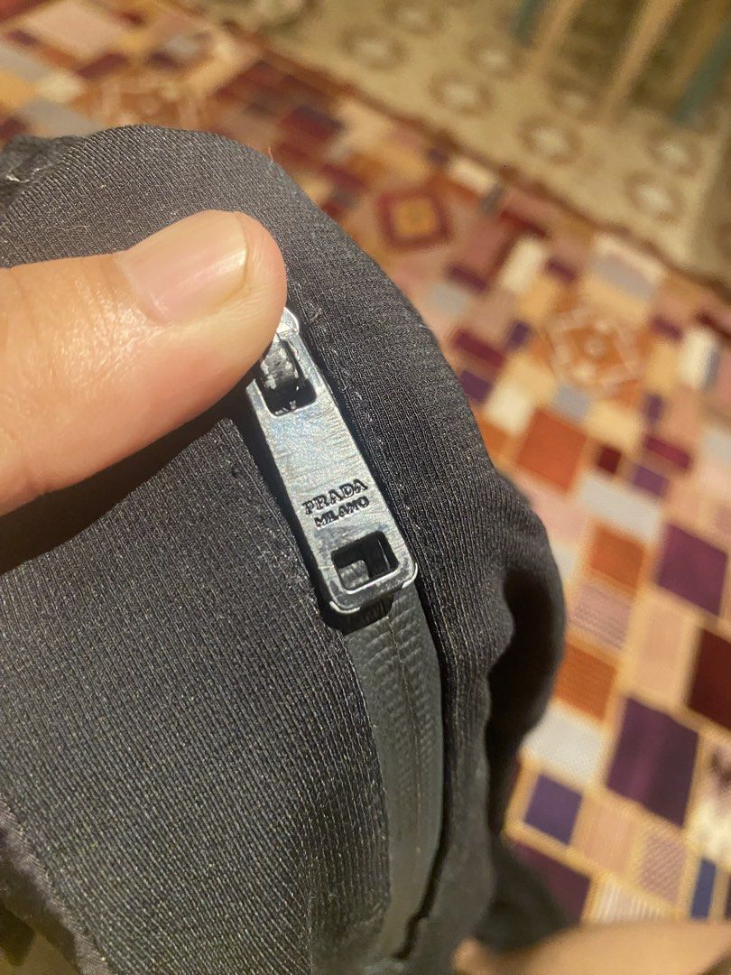 Prada Black Nylon Cargo Pants (Category: Joggers) located in Leyte. Submitted by zenoneedai35478 (Listing ID 1457708906, Image 2). Description: - Authentic Prada black cargo pants - Size 52 - Iconic Prada triangle logo on cargo pocket - Zipper details with Prada branding - Drawstring hem for adjustable fit - Made in Italy.
