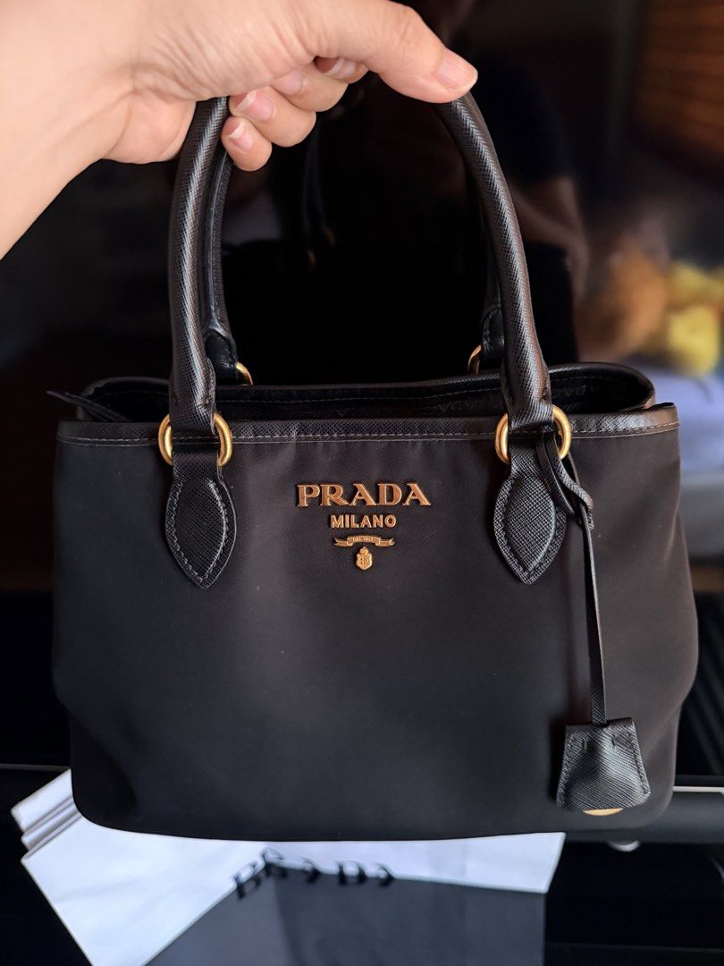 PRADA Tessuto Saffiano Nylon Bag (Category: Luxury Bags & Wallets) located in San Fernando. Submitted by ms.mlsluxeboutique (Listing ID 1457545988, Image 2). Description: •100% authentic or money back guarantee if proven fake •With paperbag, dustbag, long handle strap, authenticity card and other legit grails (rfid already) •9/10 condition •No discoloration •Minimal sign of usage in handle •In excellent used condition .