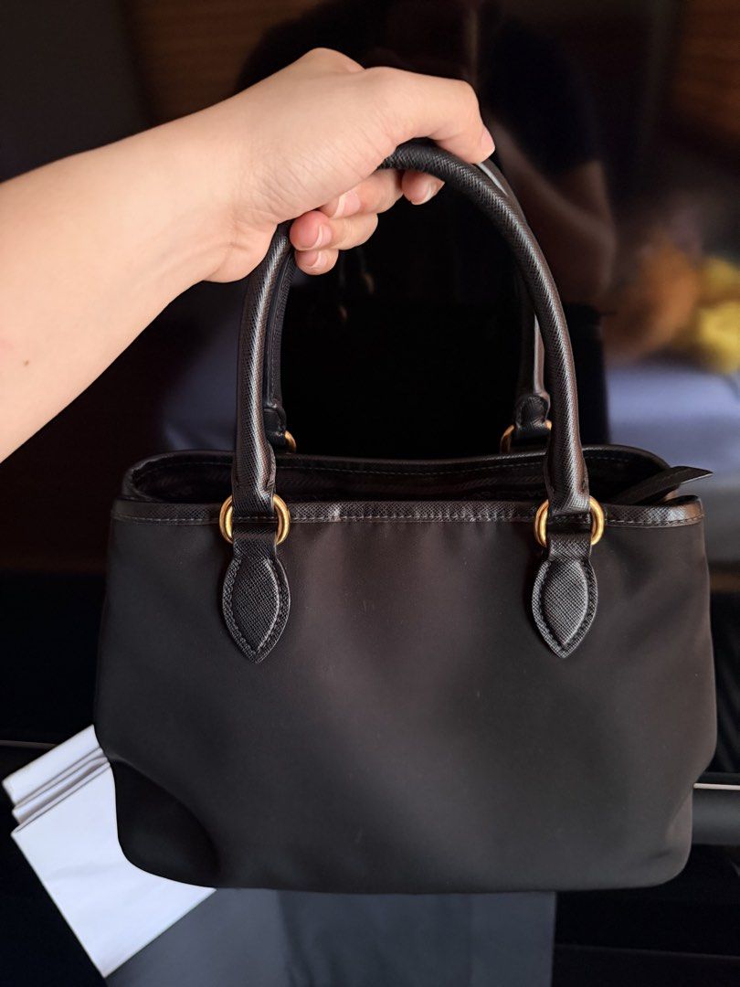 PRADA Tessuto Saffiano Nylon Bag (Category: Luxury Bags & Wallets) located in San Fernando. Submitted by ms.mlsluxeboutique (Listing ID 1457545988, Image 3). Description: •100% authentic or money back guarantee if proven fake •With paperbag, dustbag, long handle strap, authenticity card and other legit grails (rfid already) •9/10 condition •No discoloration •Minimal sign of usage in handle •In excellent used condition .