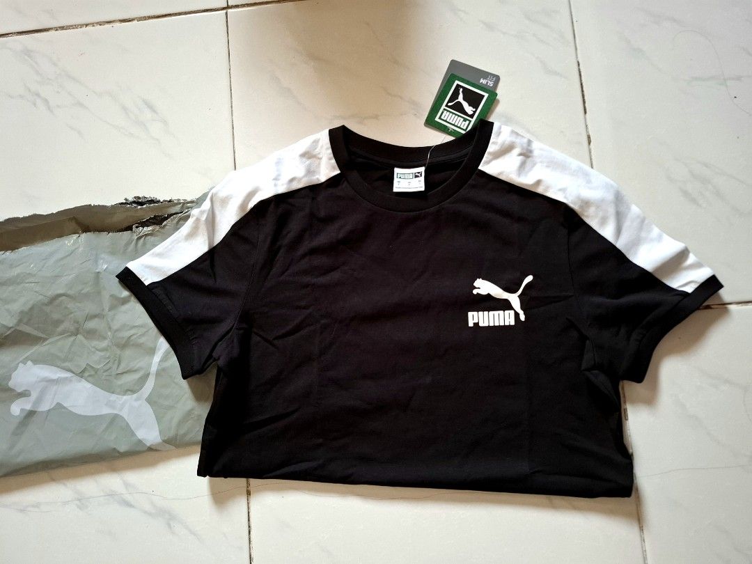 Puma Black & White T-shirt (Category: Tshirts & Polo Shirts ) located in Bulacan. Submitted by firsthand_personalstuff (Listing ID 1457670927, Image 2). Description: Steal Price!!! Authentic Puma T7 Shirt - Classic black Puma t-shirt - White accents on shoulders and sleeves - Features iconic Puma logo on the chest - Slim fit design - 17.5/26.5 - Ideal for everyday casual wear size small Mens, can be unisex with proof of purchased / 900 soft cotto