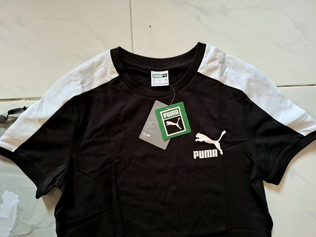 Puma Black & White T-shirt (Category: Tshirts & Polo Shirts ) located in Bulacan. Submitted by firsthand_personalstuff (Listing ID 1457670927, Image 3). Description: Steal Price!!! Authentic Puma T7 Shirt - Classic black Puma t-shirt - White accents on shoulders and sleeves - Features iconic Puma logo on the chest - Slim fit design - 17.5/26.5 - Ideal for everyday casual wear size small Mens, can be unisex with proof of purchased / 900 soft cotto