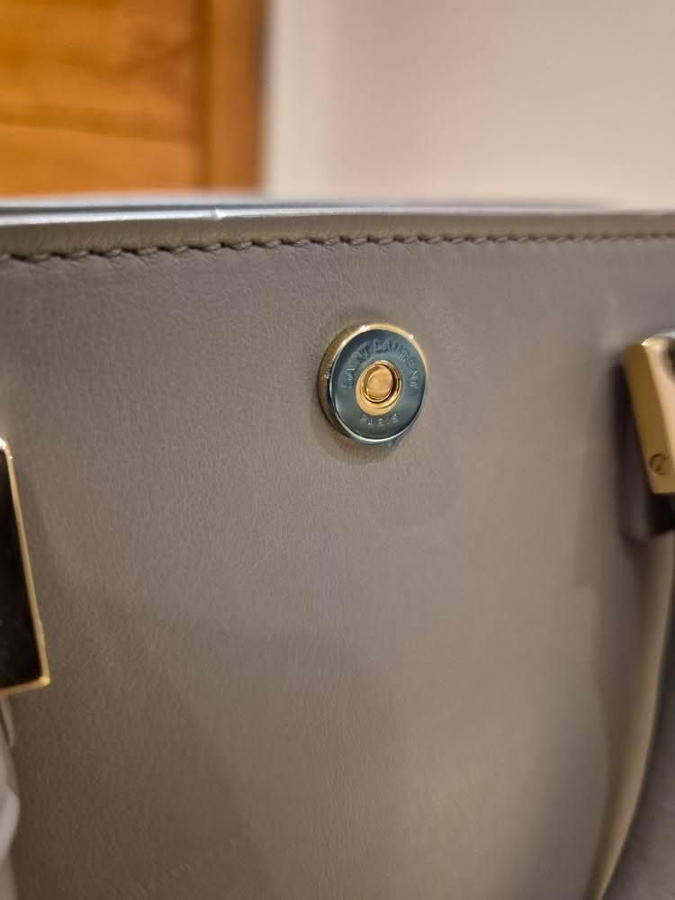 Saint Laurent Baby Cabas Bag (Category: Luxury Bags & Wallets) located in Paranaque City. Submitted by happyfindsbyc (Listing ID 1457610094, Image 3). Description: - Authentic Saint Laurent grey leather top handle bag - Features iconic gold YSL logo hardware - Comes with original dust bag - A classic and timeless piece *Bought in London *Condition: 10/10 *RFS: Decluttering.