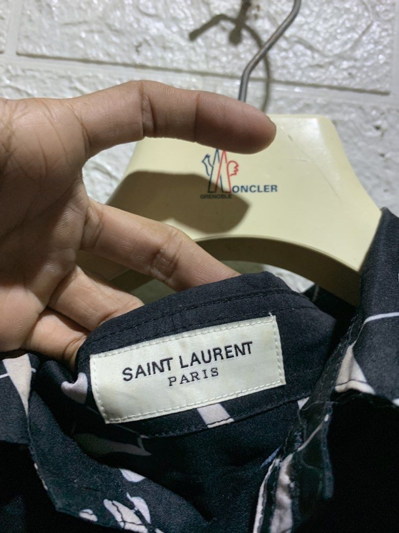 SAINT LAURENT MUSICAL NOTE SHIRT (Category: Luxury Apparel) located in General Trias. Submitted by kyledeterala6969 (Listing ID 1457590452, Image 3). Description: Saint Laurent No issue Like new Color rate - 10/10 Length - 29 Pit to pit - 23 Location: General Trias City, Cavite.