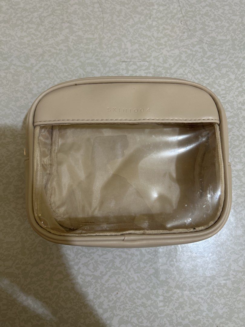 SKIN1004 Clear Cosmetic Bag (Category: Makeup) located in Angeles City. Submitted by meiyawcat (Listing ID 1457592129, Image 1). Description: - Transparent cosmetic bag with stylish beige trim. - Ideal for organizing makeup, toiletries, or travel essentials. - See your items at a glance through the clear front. - Secure zipper closure for peace of mind. - Perfect for both travel and everyday use..