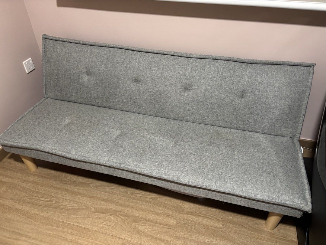 Sofa bed (Category: Sofas) located in Singapore. Submitted by eddddie (Listing ID 1457640463, Image 1). Description: - Grey fabric sofa bed - Easy conversion from sofa to bed - Simple, modern design - Wooden legs - Ideal for small spaces or guest rooms - Still functional and comfortable.