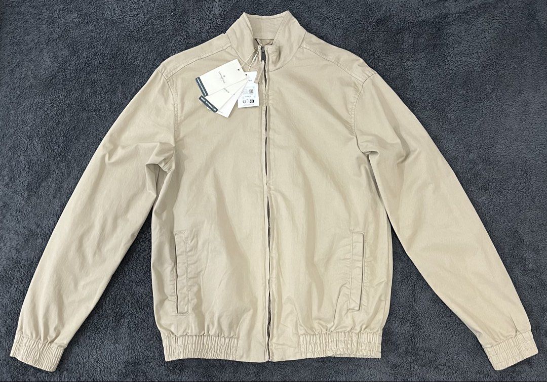 Springfield Harrington Jacket (Category: Coats, Jackets and Outerwear) located in Muntinlupa City. Submitted by invalid_ (Listing ID 1457667102, Image 1). Description: ⁃ Long sleeves with elasticized cuffs. Elasticized hem. ⁃ Stand-up collar. Full-zip front. ⁃ Two side welt pockets ⁃ Signature embroidered Leaf at the back top center ⁃ 98% Cotton, 2% Elastane. Made in China. ⁃ Beige in color, around 10/10 color rate. ⁃ Size small on tag with measu
